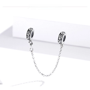 Detailed macro view of S925 sterling silver safety chain with vintage hollow vine patterns