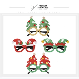 Close-up of four festive Christmas glitter glasses with reindeer and tree designs