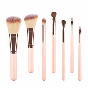 Macro shot of 7 piece mini makeup brush set with pink handles and rose gold ferrules