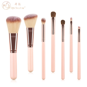 Macro shot of 7 piece mini makeup brush set with pink handles and rose gold ferrules