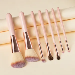 Detail showing 7-piece mini makeup brush set with rose gold ferrules and purple gradient bristles