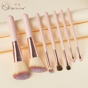 Detail showing 7-piece mini makeup brush set with rose gold ferrules and purple gradient bristles