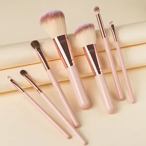 Set of 7 portable makeup brushes with soft pink handles and rose gold ferrules