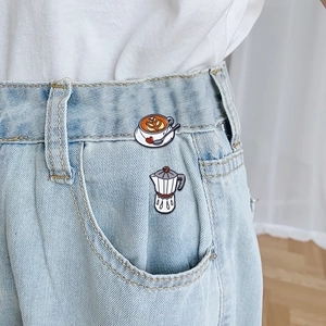 Retro cartoon coffee enamel pins with cup and moka pot design on denim fabric