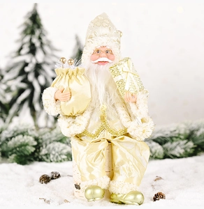 Close-up of champagne gold Santa Claus figurine with satin robes and gift box