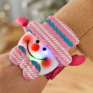 Close-up of glowing LED Christmas slap bracelet featuring a sequined cartoon snowman