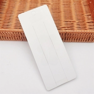 White cardboard hair clip display card with pink bear pattern and hanging hole slots