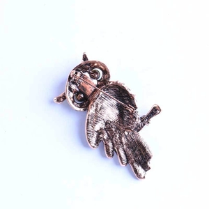 Vintage bronze owl brooch with detailed feather texture and secure pin fastening