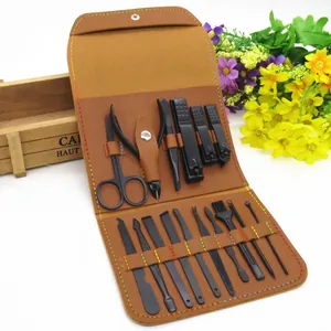 Detail of 18-piece black matte manicure set organized in a brown leather folding case
