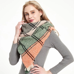 Women's cozy plaid scarf with fringe in green, beige and orange stripes for winter