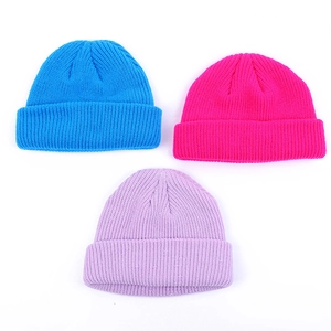 Detailed view of sky blue, rose red and lavender knitted beanies with ribbed texture