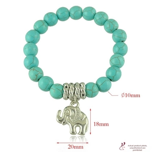 Detail of bohemian turquoise beads bracelet featuring a silver elephant charm and 10mm stones