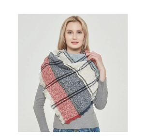 Close-up of red and blue plaid scarf featuring soft bouclé yarn and fringe tassels