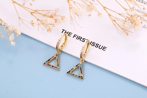 Detailed shot of gold huggie earrings with colorful triangular pavé-set gemstones