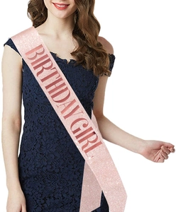 Detail of pink glitter birthday girl sash with rose gold lettering on a model