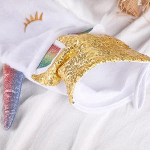 Plush unicorn Christmas stocking with golden sequins and rainbow horn hanging decoration