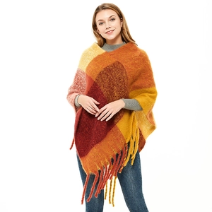 Women's plaid tassel poncho shawl in warm orange and yellow knit with fringe detail