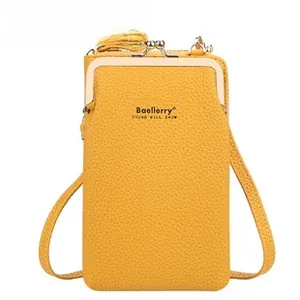 Detail of yellow lychee grain PU leather phone bag with gold metal frame closure