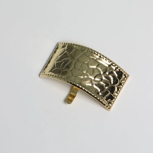 Close-up of golden hammered metal ponytail hair hook with decorative beaded edge details
