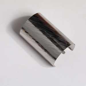 Close-up of silver hair hook with brushed metal texture and minimalist curved design