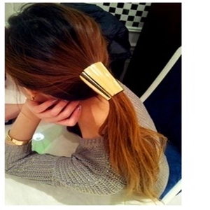 Polished gold metal ponytail cuff hair accessory shown on a model ponytail hairstyle