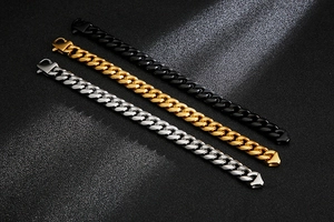 Three heavy Cuban link chain bracelets in black, gold, and silver with lobster clasps