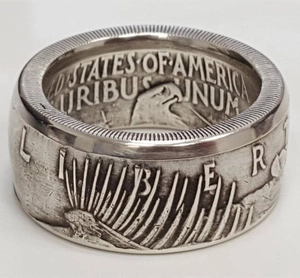 Macro detail of vintage silver coin ring showing intricate Liberty and US text engravings