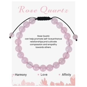 Detail of rose quartz beaded bracelet with adjustable black cord on a gift message card