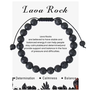 Detailed macro view of black volcanic lava rock beads on adjustable woven rope bracelet