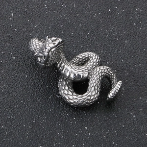 Macro shot of punk style stainless steel snake pendant with detailed scales and texture