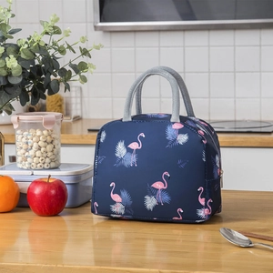 Insulated lunch bag with pink flamingo and palm leaf patterns on a navy blue base
