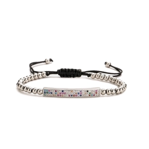 Adjustable woven bracelet with silver beads and rainbow cubic zirconia bar on white background