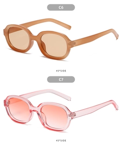 Detail view of oval concave sunglasses in translucent brown and pink jelly colors