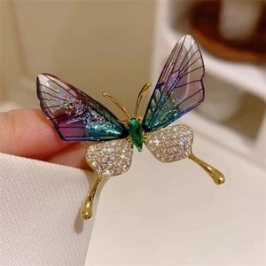 Macro shot of butterfly brooch featuring purple gradient wings and gold-plated zircon inlay