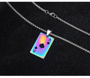 Macro shot of colorful iridescent ace of spades poker pendant on a metal chain necklace
