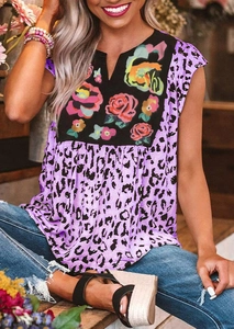 Detail of V-neck top with leopard print and floral embroidery on a purple background