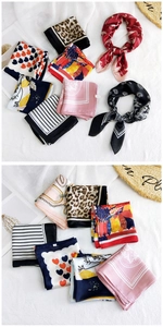 Detail view of assorted fashion square silk scarves with leopard and floral prints