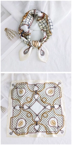 Detail view of square silk scarf with paisley chain patterns and smooth satin texture