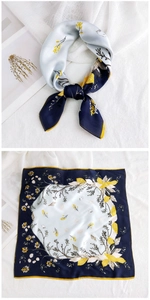 Detail of floral printed square silk scarf with navy blue borders and yellow flower patterns