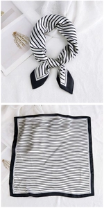 Detail of black and white striped silk square scarf showing folded and flat textures