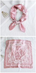 Detailed view of pink paisley silk scarf showing styling and flat square layout
