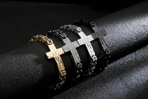 Close-up of four titanium steel Byzantine bracelets with cross charms in gold and silver