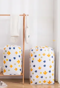 Close-up of waterproof PEVA quilt storage bag with drawstring and leaf print pattern