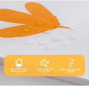 Detailed macro shot showing waterproof PEVA fabric with orange heart pattern and water droplets
