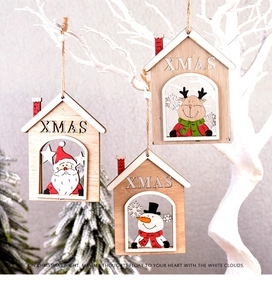 Close-up of wooden Christmas tree ornaments featuring hand-painted Santa and reindeer motifs