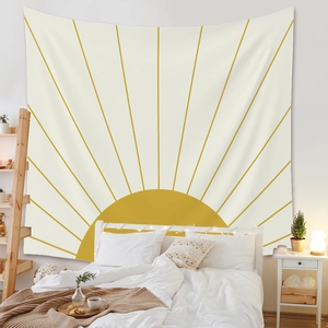 Bohemian sun tapestry with yellow geometric pattern hanging in a cozy modern bedroom