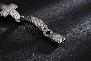 Detailed macro view of punk style stainless steel bracelet with cross engraving