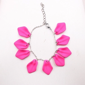 Bohemian style bracelet featuring pink petal charms and silver metal chain link design