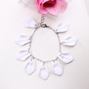 Detail of silver chain bracelet with white petal charms and lobster clasp closure
