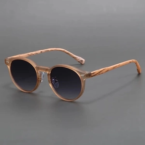 Retro round matte sunglasses with amber frames and wood grain temples in a side view